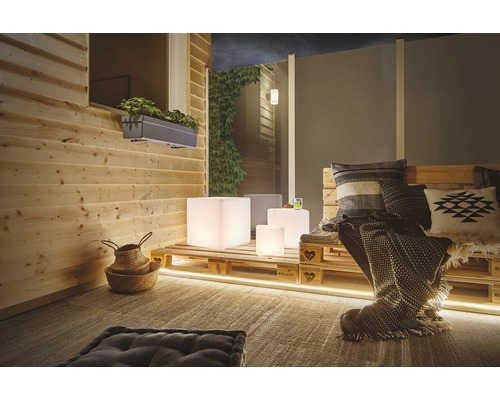 Mysig terrass med träpanel, pallmöbler och stämningsfull belysning