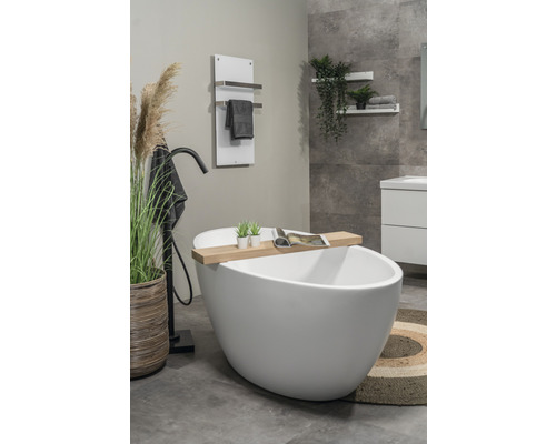 Badrum med fristående badkar, handdukstork och dekorationer