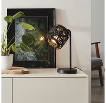 Dekorativ bordslampa i metall med modern design på en byrå