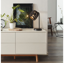 Bordslampa av metall på byrå med dekoration i vardagsrummet