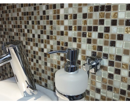Badrum med mosaikplattor, vattenkran och tvålpump