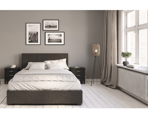 Sovrum med säng, sängbord, golvlampa och dekoration