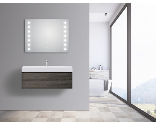 Modernt badrum med tvättställsskåp, tvättställ och upplyst spegel