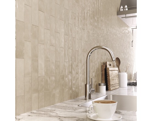 Köksscen med väggplattor, diskho och kran