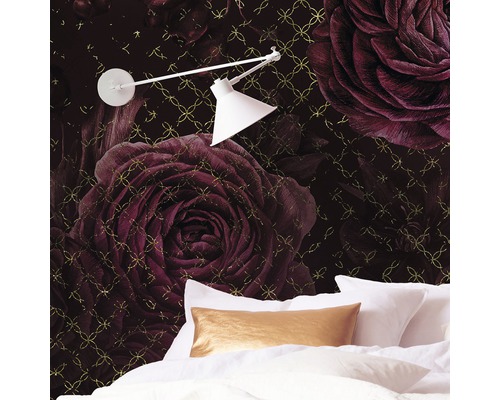 Sovrum med tapet med rosmönster, säng och lampa