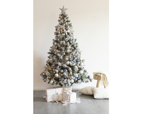 Dekorerad julgran med stjärna, julgranskulor och julklappar