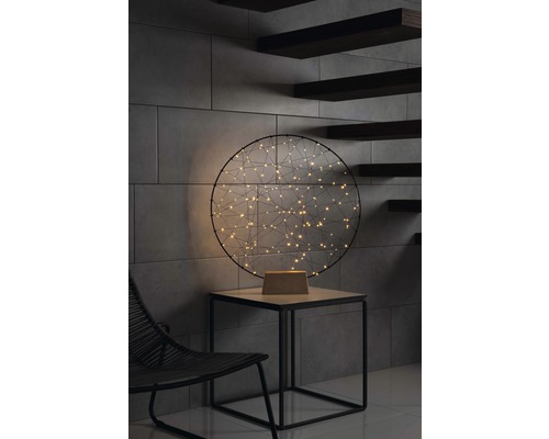 Julbelysning KONSTSMIDE 160 bärnstensfärgade LED metallring med träfot svart Dekorativ bordslampa med LED-lampor på ett sidobord