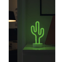 Dekorativ bordslampa i neon som ser ut som en kaktus på ett nattduksbord