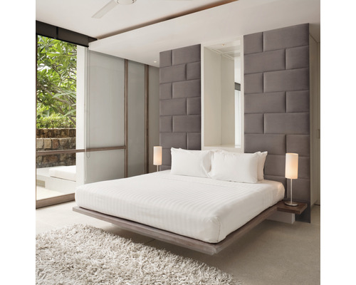 Ljust sovrum med dubbelsäng, sänglampor och fönster