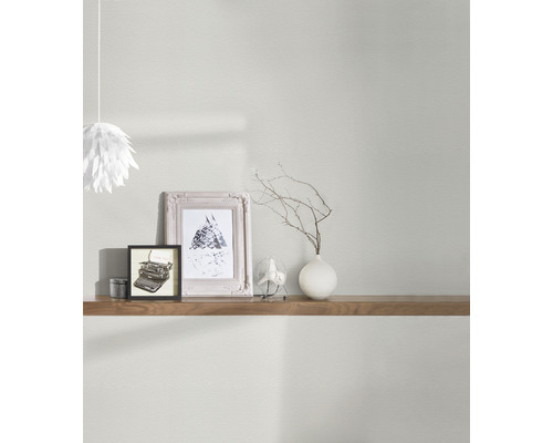 Väggdekoration med bilder, dekorationer och en hylla