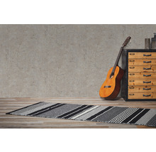 Miljöbild med gitarr, byrå och randig matta