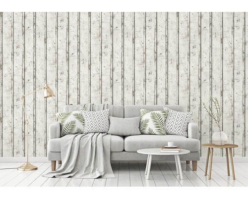 Vardagsrum med tapet i trälook, soffa, bord och golvlampa