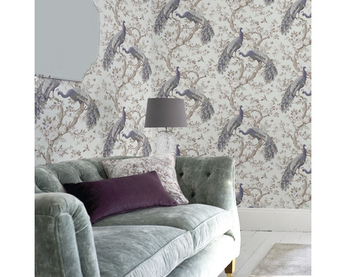 Vardagsrum med tapet med påfågelsmönster, soffa och lampa