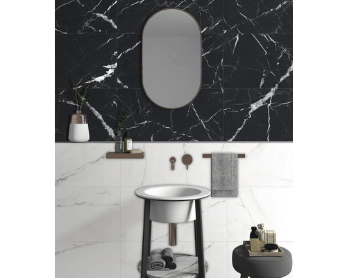 Badrum med handfat, spegel och kakel i marmorlook