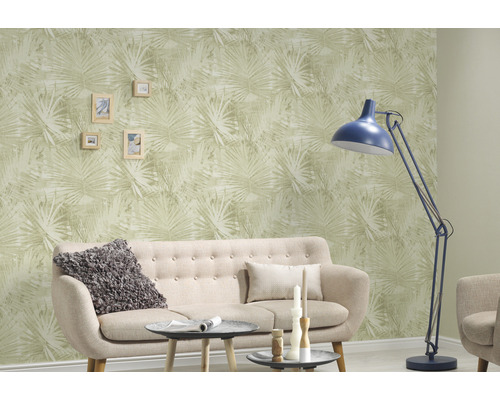 Vardagsrum med soffa, golvlampa och tapet med växtmönster