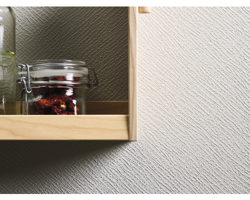 Hylla med konserveringsburkar framför en strukturtapet