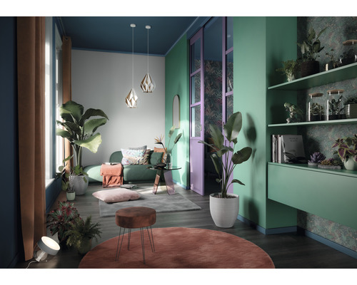 Vardagsrum med soffa, växter, matta och hyllor för en dekorativ inredning