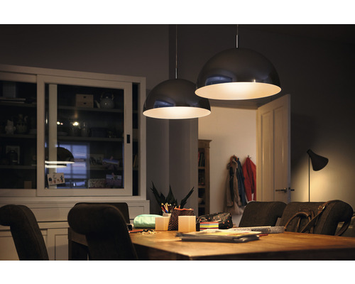 Matsal med träbord och två runda hänglampor