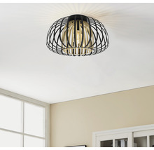 Svart och guldfärgad taklampa med burdesign