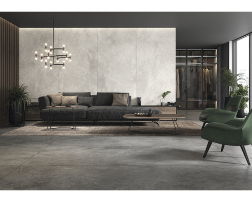 Modernt vardagsrum med soffa, fåtöljer, matta och belysning