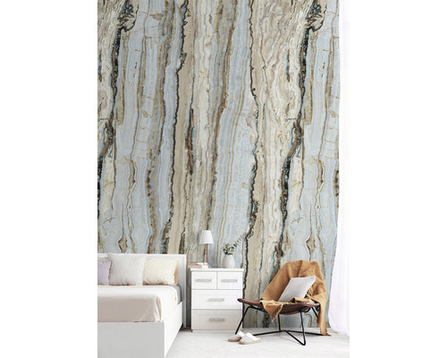 Sovrum med fototapet i marmorimitation, säng, sängbord och fåtölj