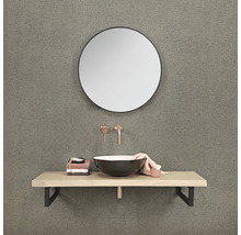 Badrum med rund spegel, tvättställsskål, tvättställsskiva och armaturer