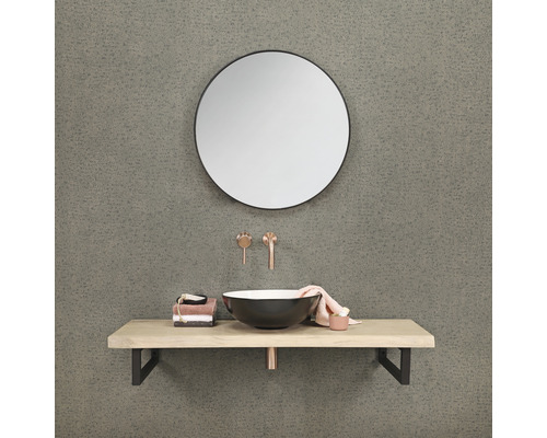 Badrum med rund spegel, tvättställsskål, tvättställsskiva och armaturer