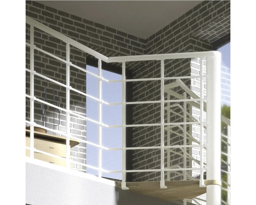 Scen av en spiraltrappa med vit räcke framför en tegelvägg