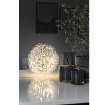 Dekorativ LED-ljusobjekt i sfärisk form på ett bord