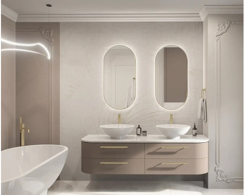 Ljust badrum med dubbla handfat, ovala speglar med belysning och badkar