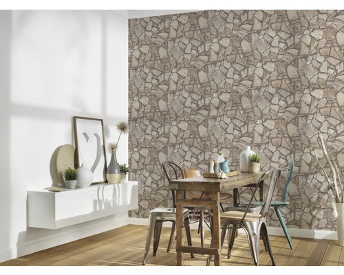 Vardagsrum med stenvägg, bord och stolar för en naturlig atmosfär