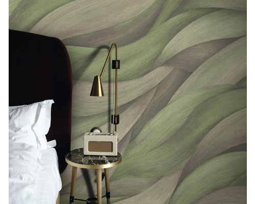 Sovrum med mönstrad tapet, sänglampa och säng