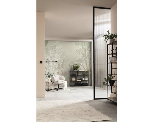 Vardagsrum med fåtölj, hylla och mönstrad tapet