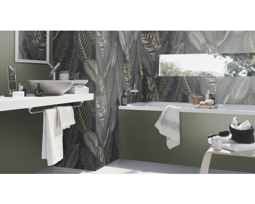 Badrum med handfat, badkar och väggplattor med bladmönster