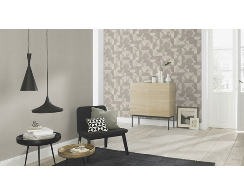 Vardagsrum med geometrisk tapet, skänk och pendellampor för en ljus och modern atmosfär.