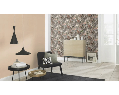 Vardagsrum med blommig tapet, skänk, stol, matta och hänglampor