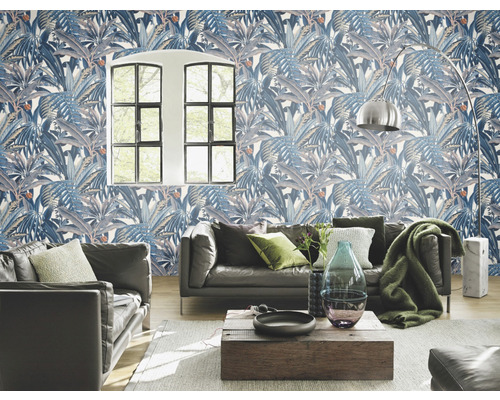 Vardagsrum med blåmönstrad blad tapet, soffa och träbord