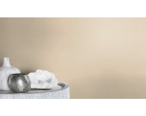 Dekorativ scen med en marmorerad vas, en värmeljushållare i metall och en kvartskristall på ett utsmyckat bord