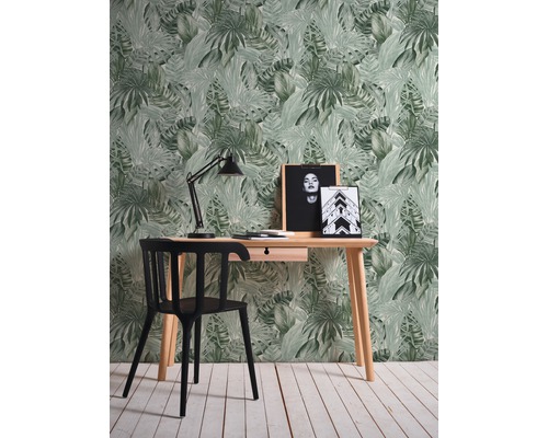 Arbetsrum med skrivbord, stol, skrivbordslampa och tropisk blad tapet