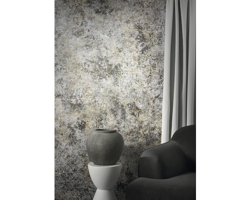 Dekorativ interiör med mönstrad tapet, vas på piedestal och en fåtölj