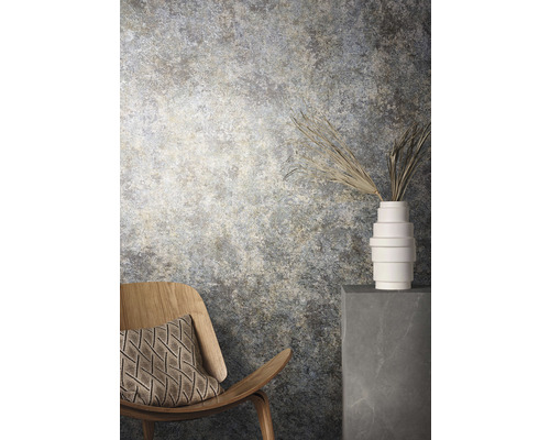 Dekorativ interiör med stol, kudde, blomvas och mönstrad vägg