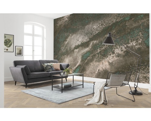 Vardagsrum med grå soffa, bord, lampa och fototapet med abstrakt mönster