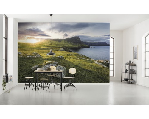 Vardagsrum med fototapet av ett kustlandskap, matbord och stolar