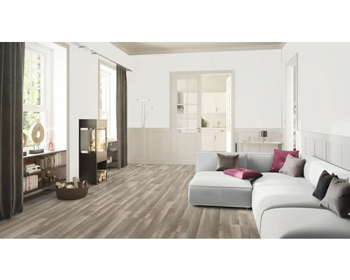 Vardagsrum med trägolv, soffa och vedeldad kamin