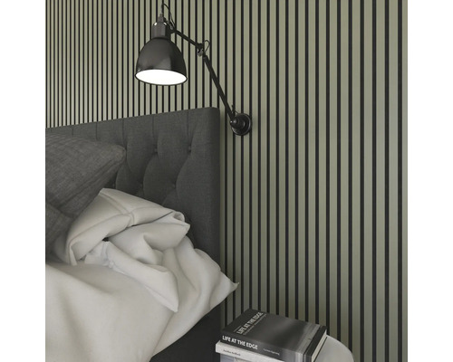 Sovrumsvägg med träpaneler, sänggavel och justerbar vägglampa.