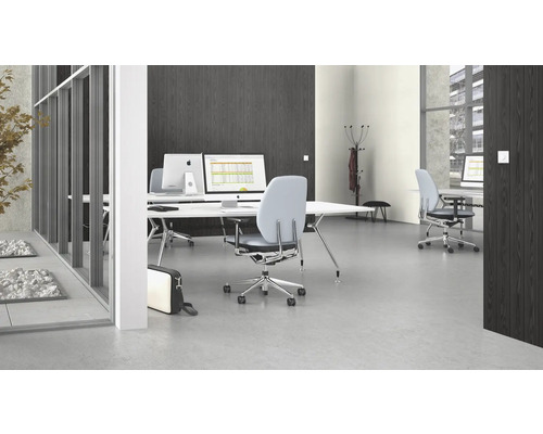 Kontorsutrymme med skrivbord, kontorsstolar och datorer