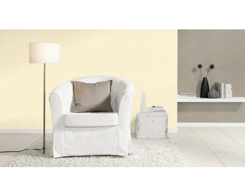 Vardagsrum med fåtölj, golvlampa och vägghylla