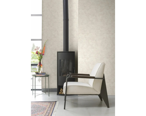 Vardagsrum med kamin, fåtölj, bord och mönstrad tapet.