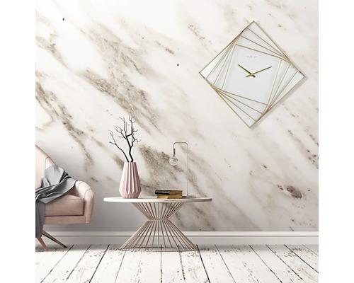 Dekorativt rum med rosa fåtölj, bord med vas, lampa och fyrkantig väggklocka