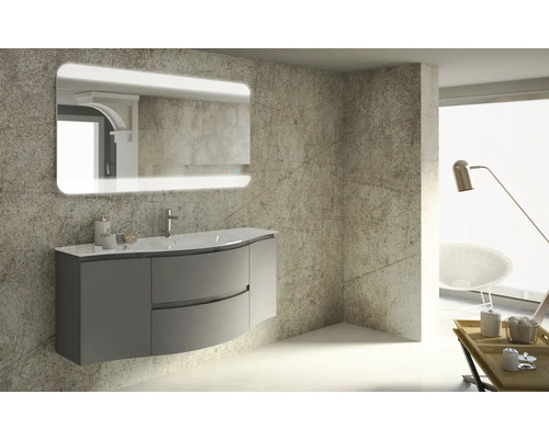 Modernt badrum med tvättställsskåp, tvättställ och upplyst spegel